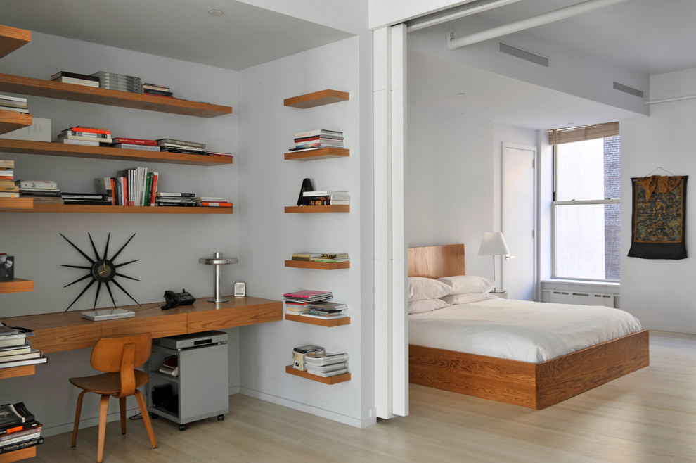 Design ideas for a contemporary bedroom in New York with white walls and light hardwood floors.