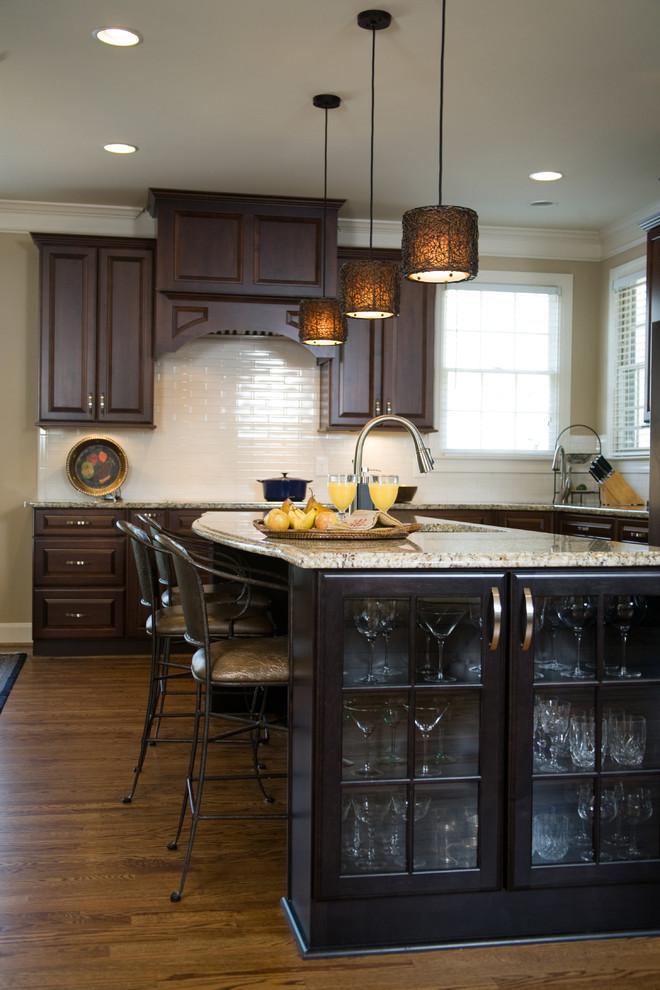 Photo of a traditional open plan kitchen in Atlanta with medium wood cabinets and stainless steel appliances.