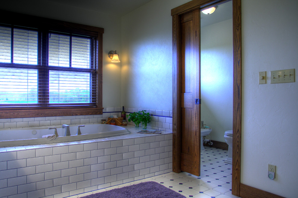 Mid-sized traditional master bathroom in Other with a drop-in tub, a double shower, a two-piece toilet, white tile, subway tile, white walls, ceramic floors and tile benchtops.