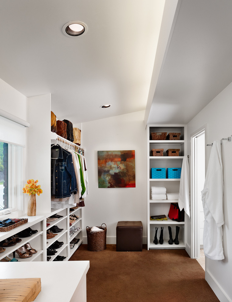 This is an example of a modern dressing room in Austin with open cabinets, white cabinets and carpet.