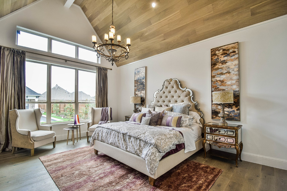 Large transitional master bedroom in Dallas with white walls and light hardwood floors.