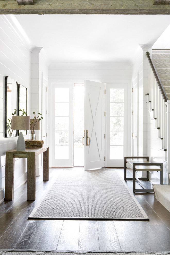 Design ideas for a mid-sized country foyer in New York with white walls, dark hardwood floors, a single front door and a white front door.