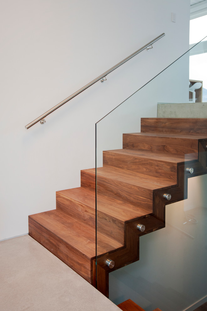 Photo of a mid-sized contemporary wood u-shaped staircase in Vancouver with wood risers.