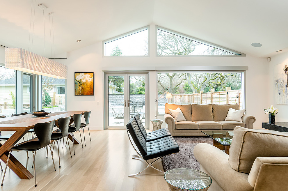 Contemporary open concept living room in Vancouver with light hardwood floors.