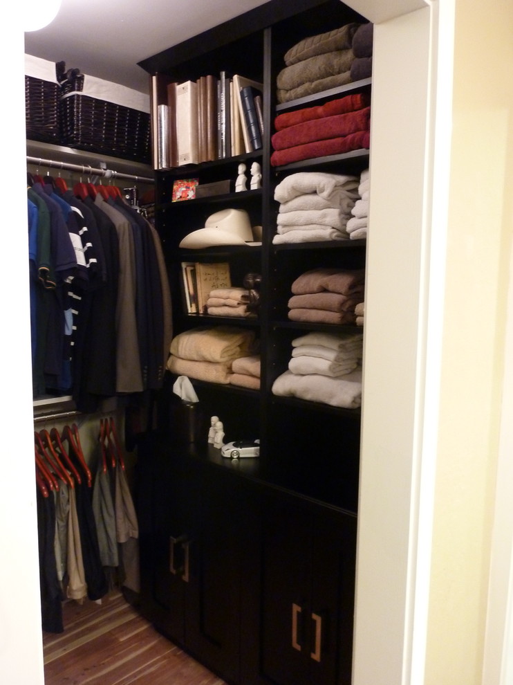 Design ideas for a small traditional men's walk-in wardrobe in San Francisco with raised-panel cabinets, black cabinets and medium hardwood floors.