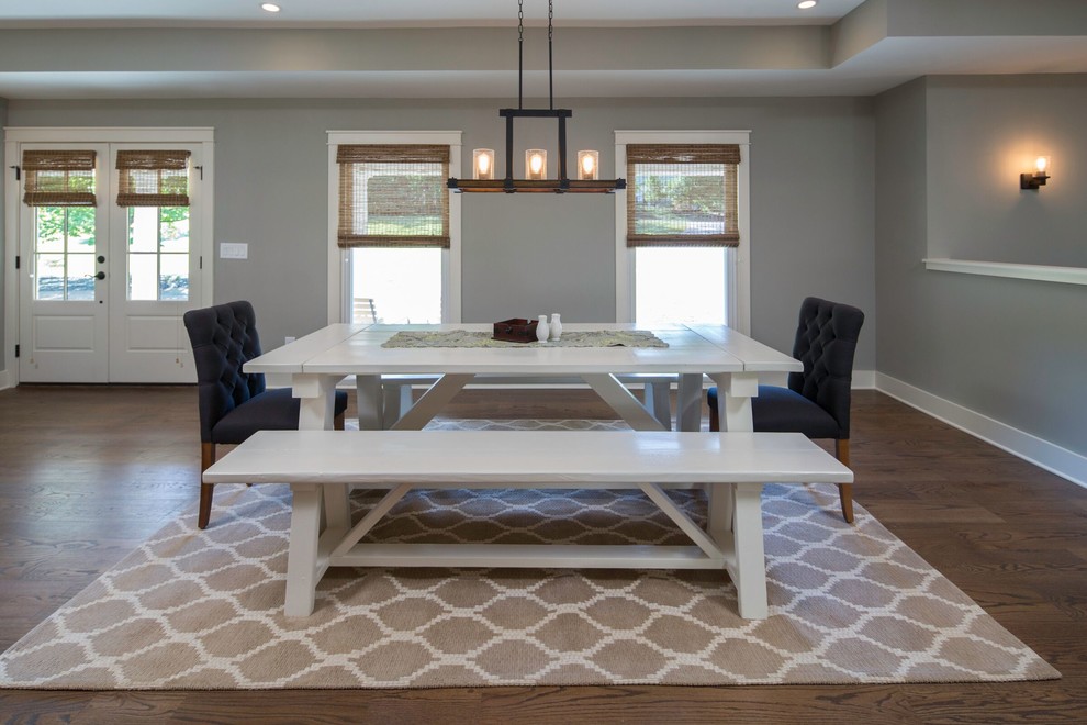 This is an example of a country open plan dining in Atlanta with grey walls, medium hardwood floors and brown floor.