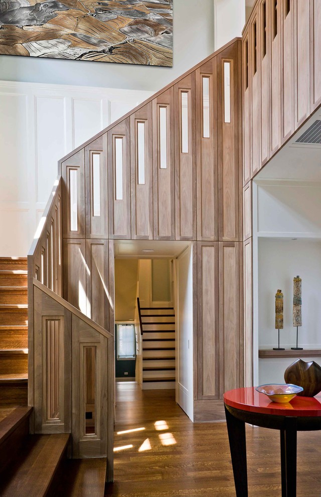 Inspiration for a large transitional wood u-shaped staircase in Chicago with wood risers.