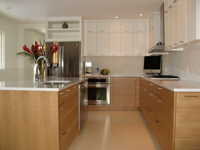 Photo of a mid-sized modern l-shaped eat-in kitchen in Calgary with an undermount sink, flat-panel cabinets, white cabinets, quartz benchtops, grey splashback, ceramic splashback, stainless steel appliances, linoleum floors and with island.