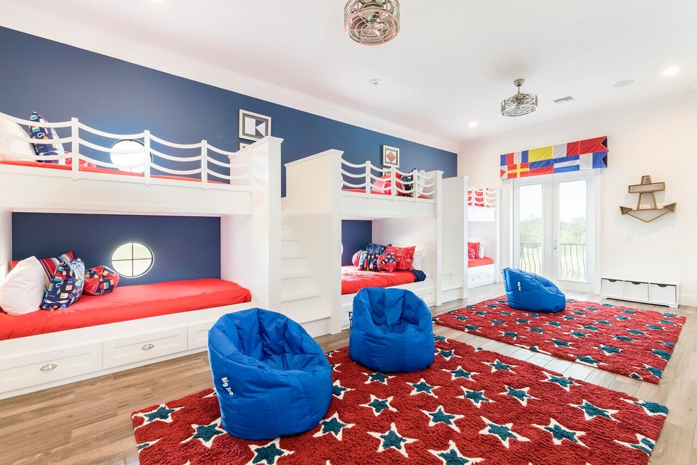 Beach style gender-neutral kids' bedroom in Orlando with white walls and light hardwood floors for kids 4-10 years old.