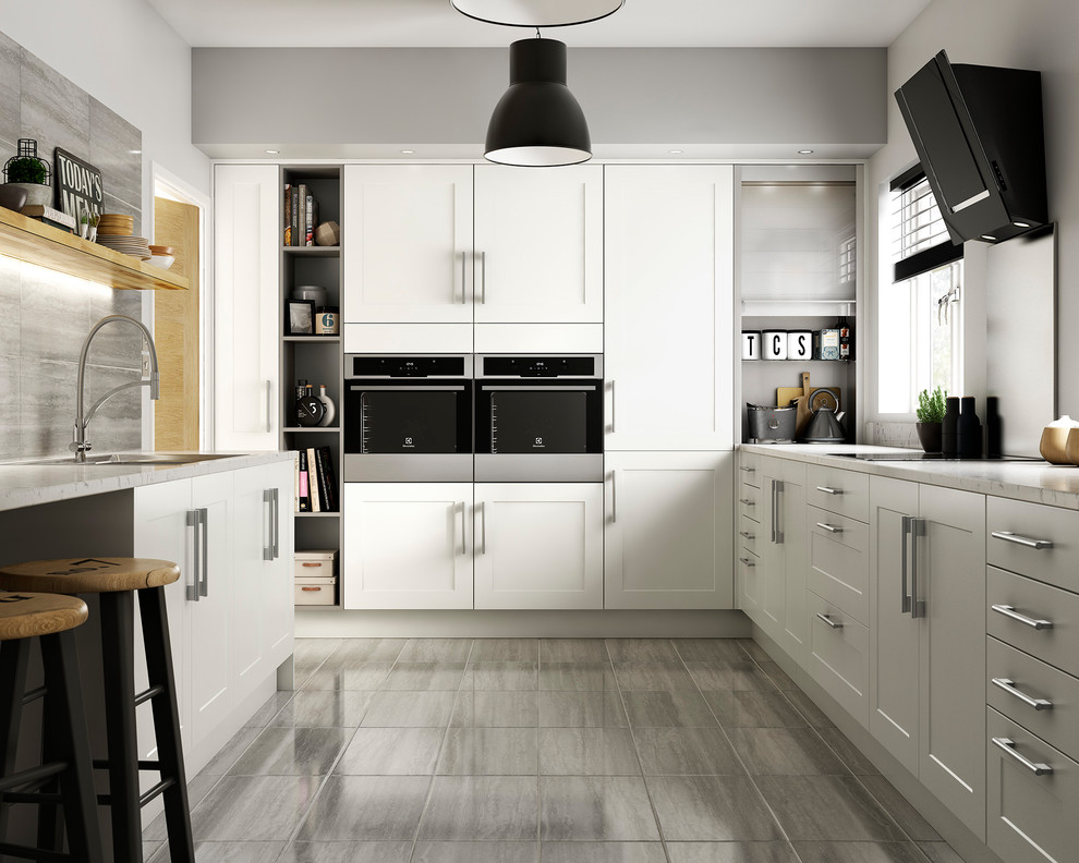 Photo of a mid-sized contemporary l-shaped separate kitchen in Other with recessed-panel cabinets, white cabinets, metallic splashback, metal splashback, panelled appliances, a peninsula, brown floor and porcelain floors.