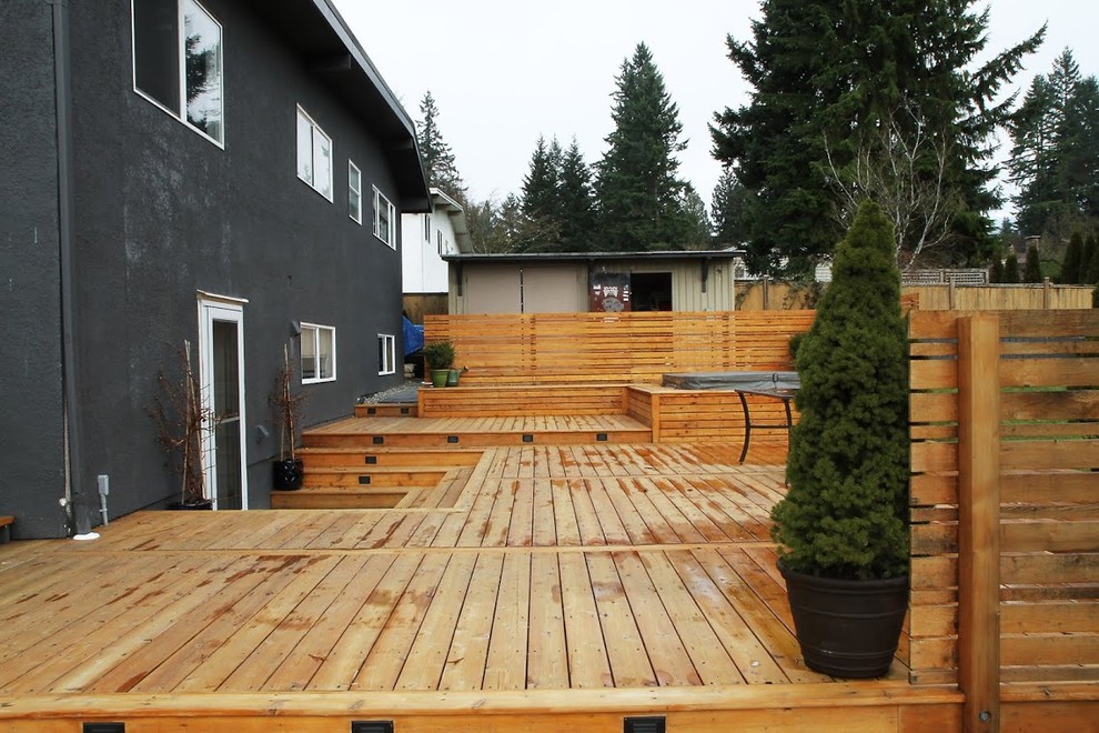 Photo of a large country backyard deck in Vancouver with a water feature and no cover.