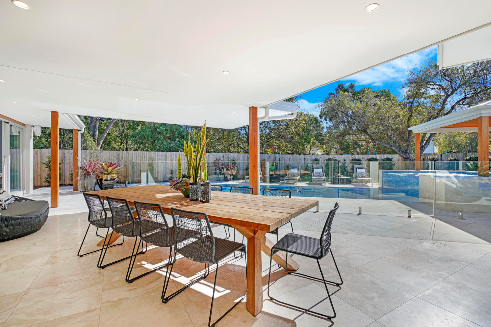 Photo of a contemporary patio in Central Coast with a roof extension.