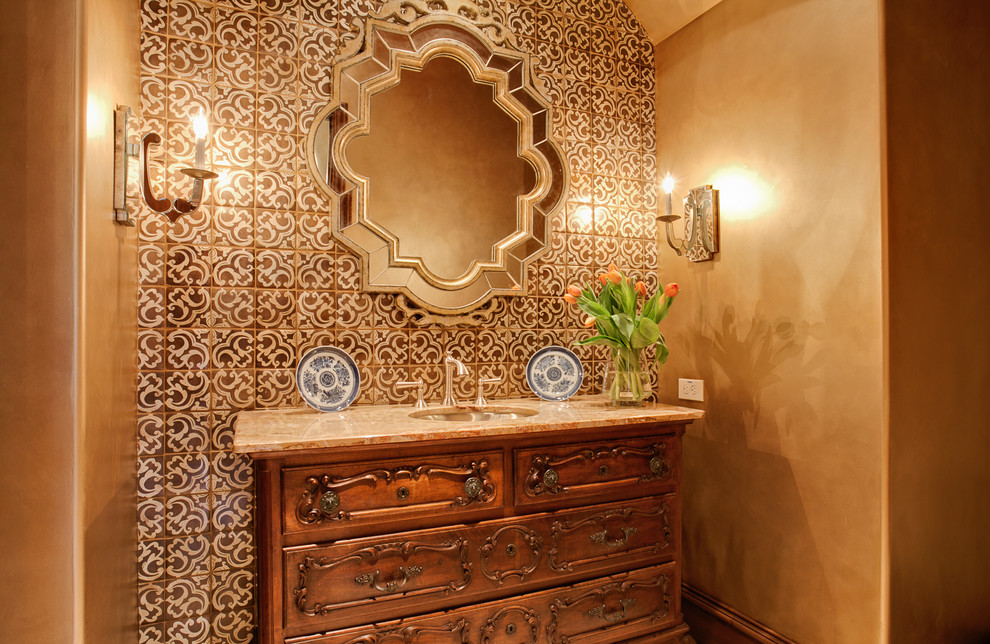 Photo of a mediterranean powder room in Dallas with an undermount sink, medium wood cabinets, multi-coloured tile, brown walls and brown benchtops.