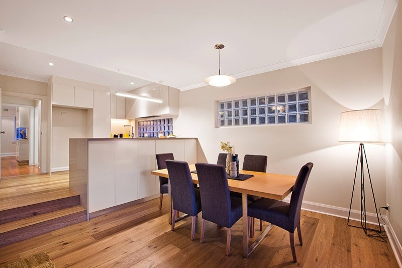 Inspiration for a mid-sized contemporary dining room in Sydney with white walls and medium hardwood floors.