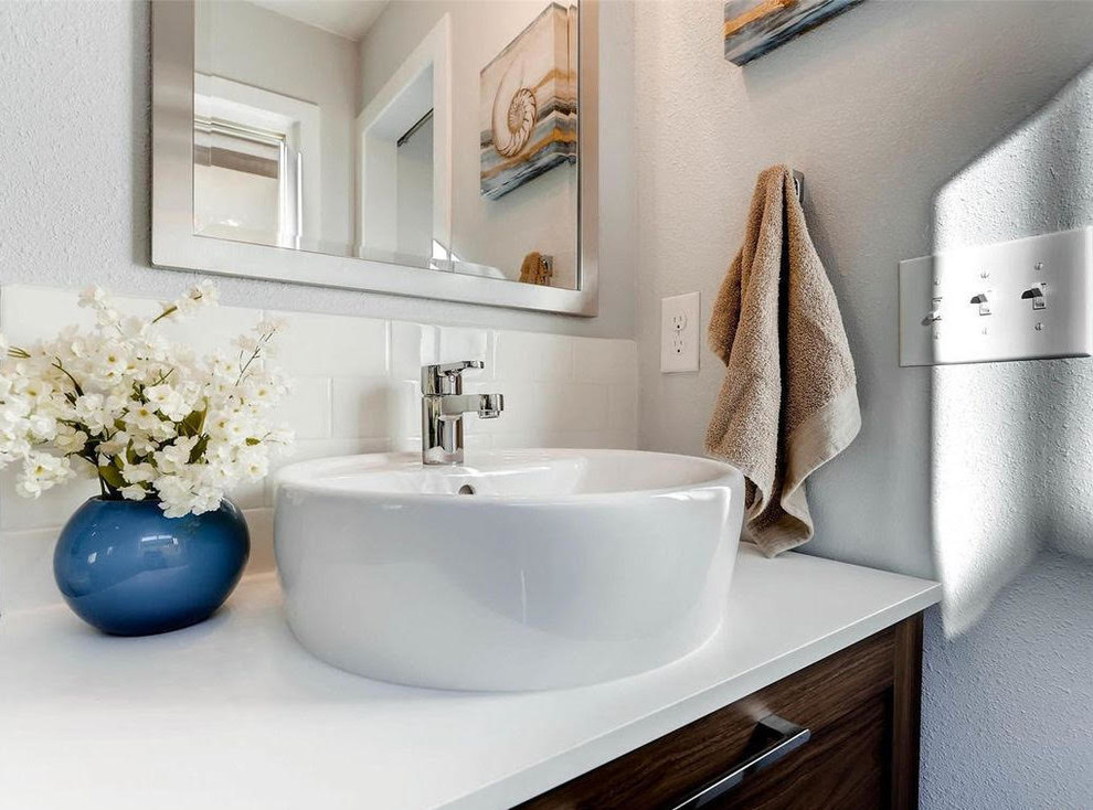 Mid-sized transitional 3/4 beige tile and ceramic tile alcove bathtub photo with shaker cabinets, white cabinets, a two-piece toilet, white walls, a vessel sink and quartz countertops