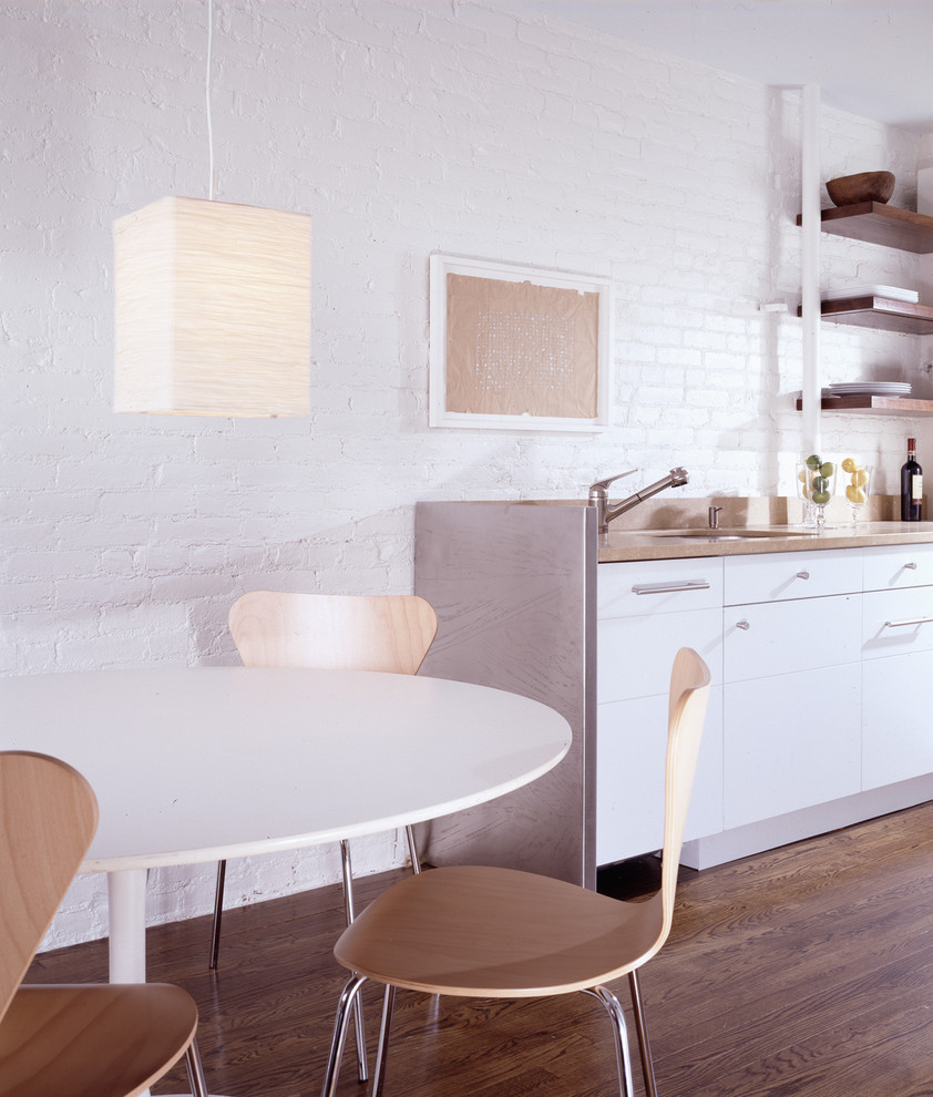 Inspiration for a contemporary eat-in kitchen in New York with white cabinets and white splashback.