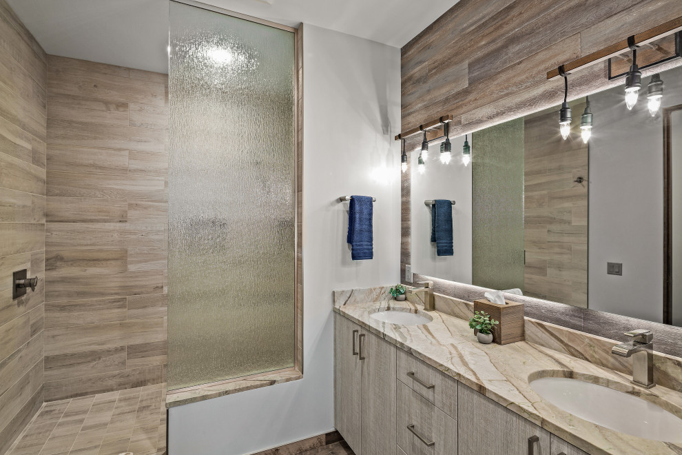 This is an example of a contemporary bathroom in Phoenix with flat-panel cabinets, dark wood cabinets, an undermount tub, gray tile, grey walls, an undermount sink, brown floor, grey benchtops, a double vanity and a floating vanity.
