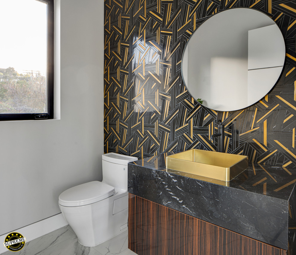 Inspiration for a small modern bathroom in Los Angeles with a one-piece toilet, marble floors, a vessel sink, marble benchtops, white floor, an enclosed toilet, flat-panel cabinets, brown cabinets, multi-coloured tile, black benchtops, a single vanity and a built-in vanity.