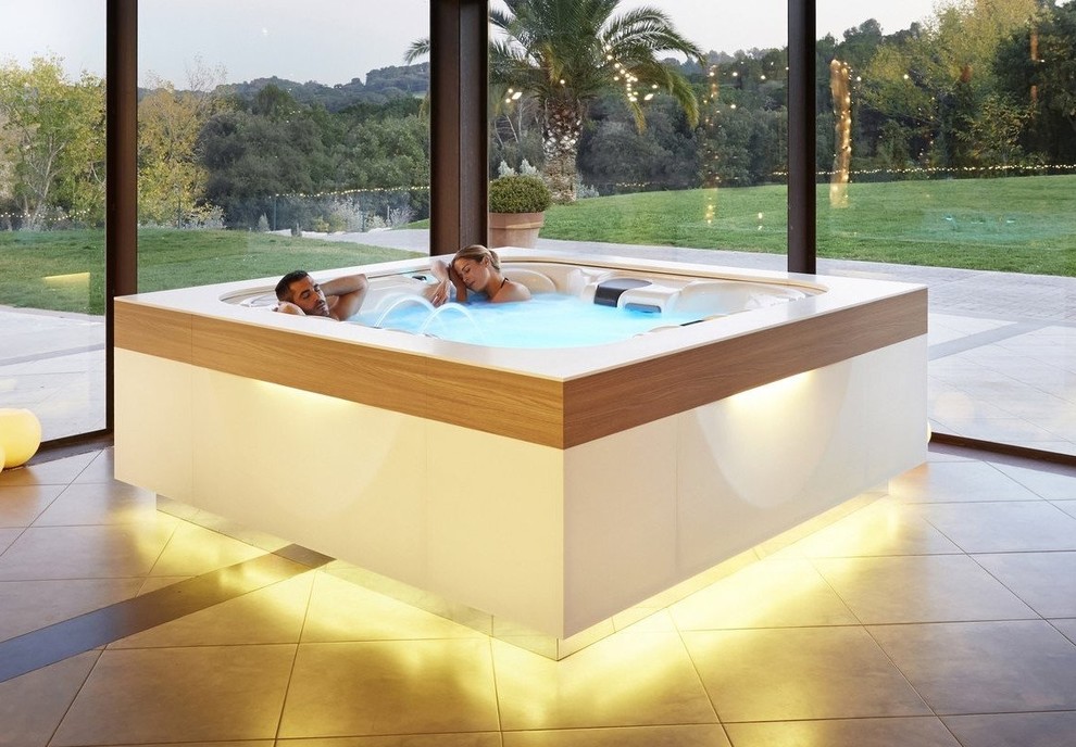 Large modern backyard rectangular pool in Miami with a hot tub.