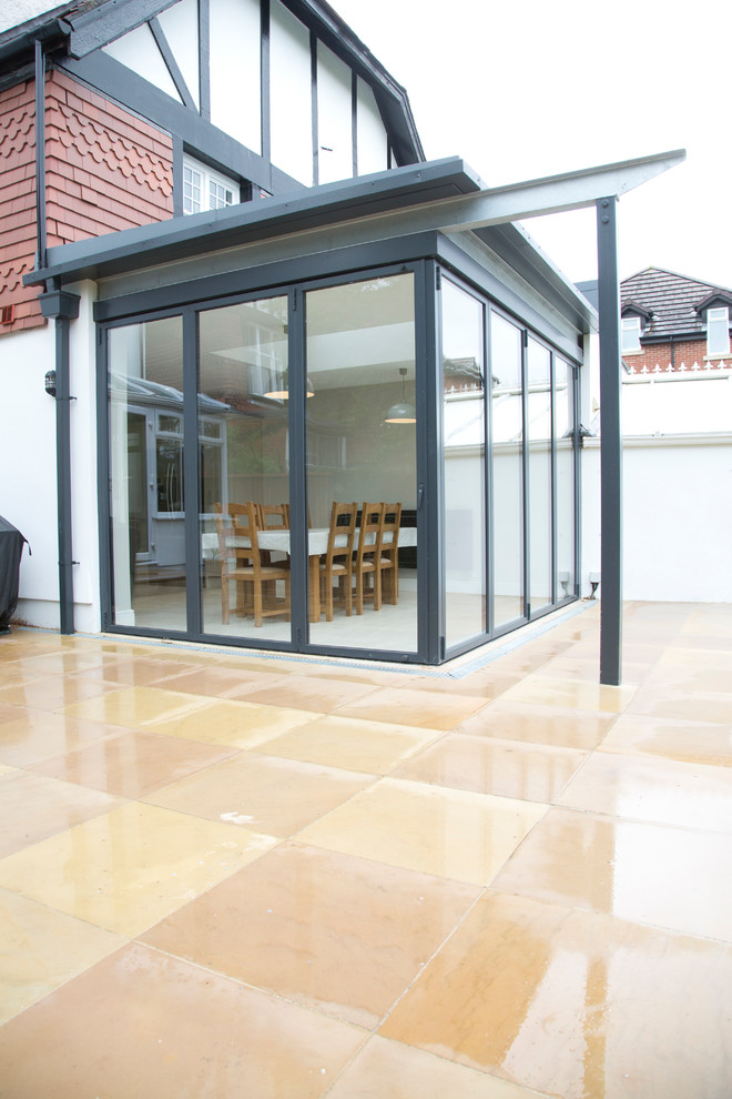 This is an example of a large traditional sunroom in Cardiff.