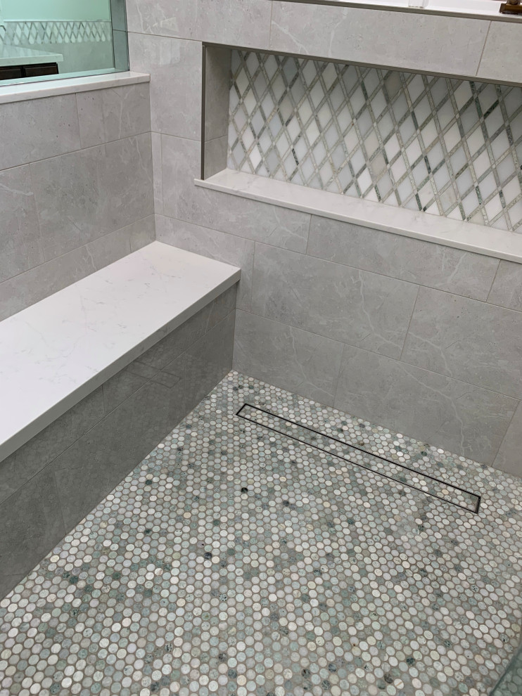 Photo of a large traditional master bathroom in Los Angeles with raised-panel cabinets, dark wood cabinets, a freestanding tub, a curbless shower, a two-piece toilet, green tile, porcelain tile, green walls, porcelain floors, an undermount sink, engineered quartz benchtops, beige floor, a hinged shower door, white benchtops, a double vanity, a built-in vanity, vaulted and decorative wall panelling.