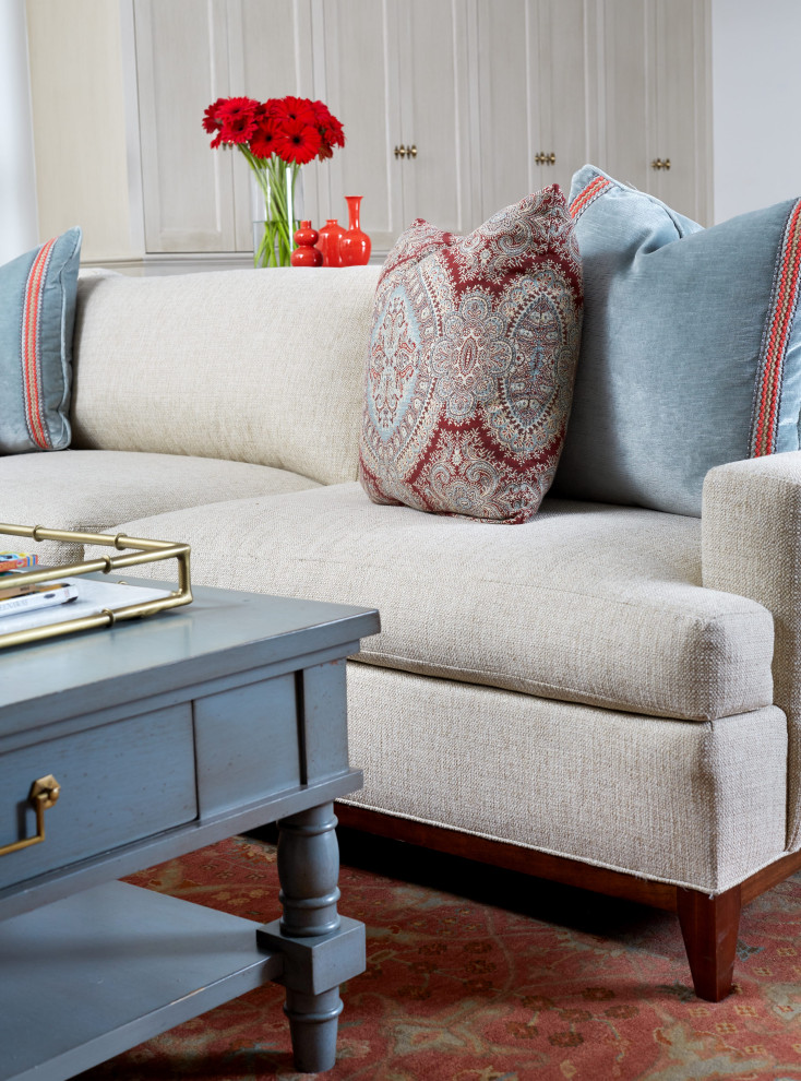 #mcleanrenovation - Rec Room Sectional with Blue & Red Throw Pillows - Bright and cheerful basement rec room with beige sectional, game table, built-in storage, and aqua and red accents.

Photo by Stacy Zarin Goldberg Photography