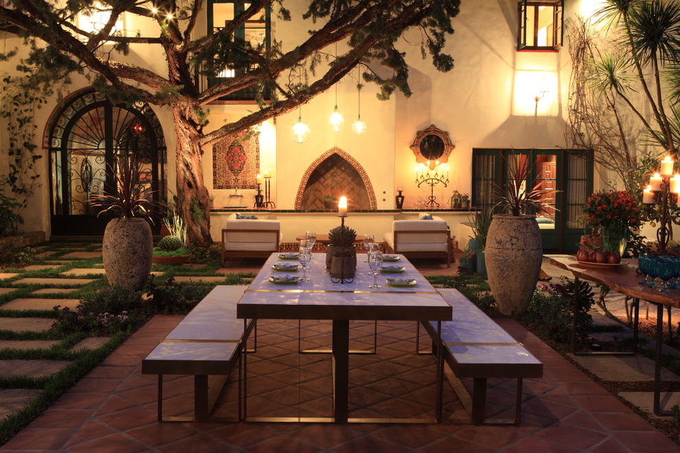Mediterranean courtyard patio in Los Angeles with a fire feature.