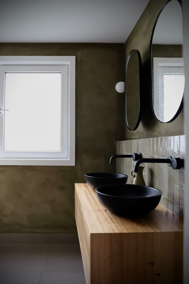 Inspiration for a bathroom in Canberra - Queanbeyan with medium wood cabinets, green tile, green walls, wood benchtops, a double vanity and a floating vanity.