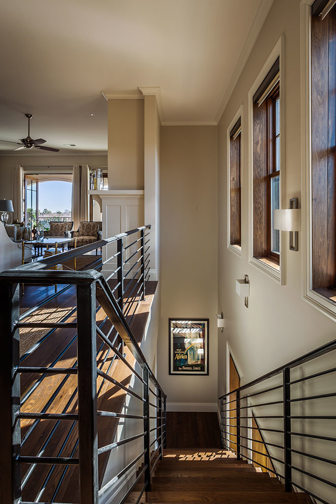 Example of a large transitional wooden straight metal railing staircase design with wooden risers