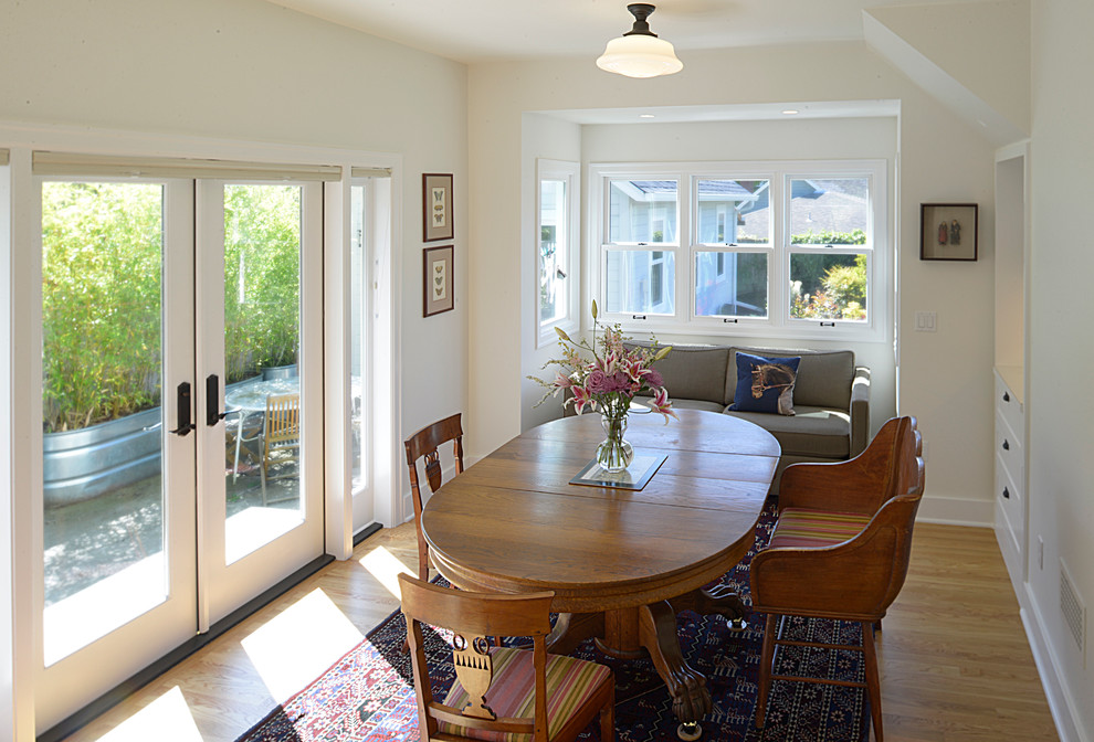 Small traditional separate dining room in Portland with white walls and medium hardwood floors.