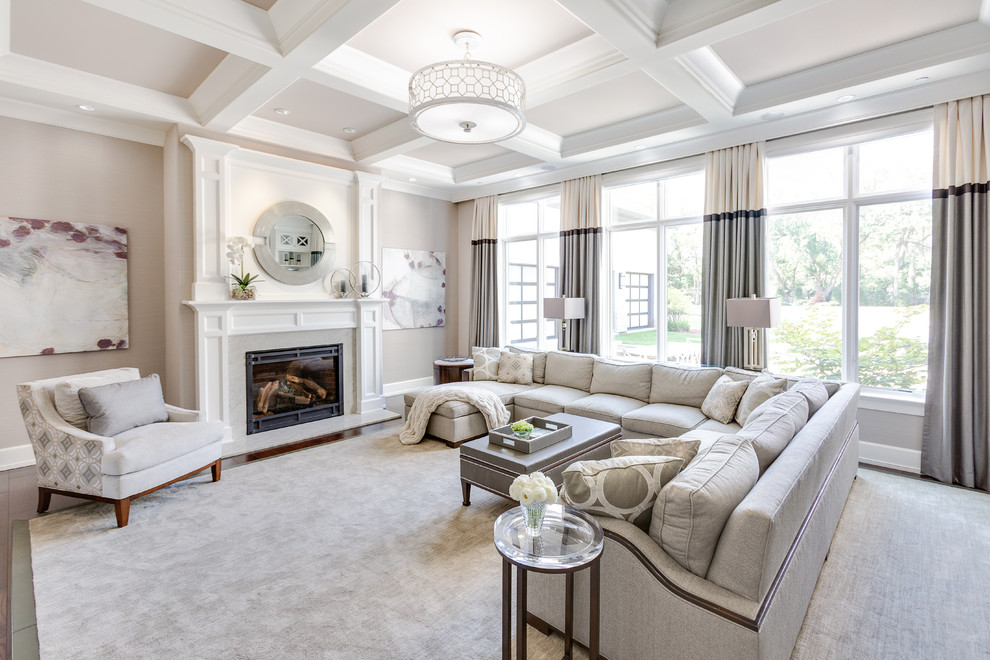 Design ideas for a large transitional open concept living room with grey walls, dark hardwood floors, a standard fireplace, a tile fireplace surround, no tv and brown floor.