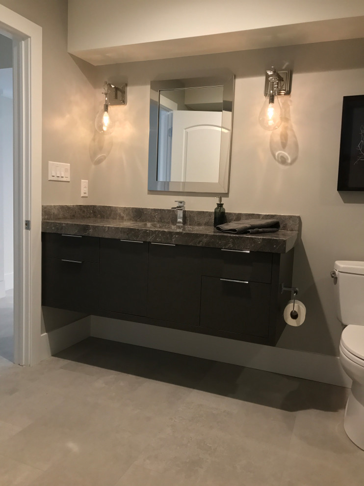 This is an example of a mid-sized modern master bathroom in Philadelphia with flat-panel cabinets, grey cabinets, a double shower, a two-piece toilet, gray tile, matchstick tile, white walls, ceramic floors, an undermount sink, marble benchtops, grey floor, a hinged shower door, grey benchtops, a single vanity and a floating vanity.