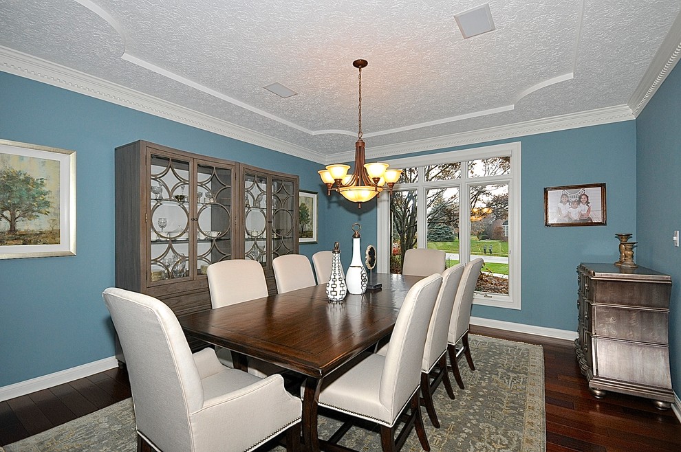 Transitional separate dining room in Indianapolis with blue walls and medium hardwood floors.