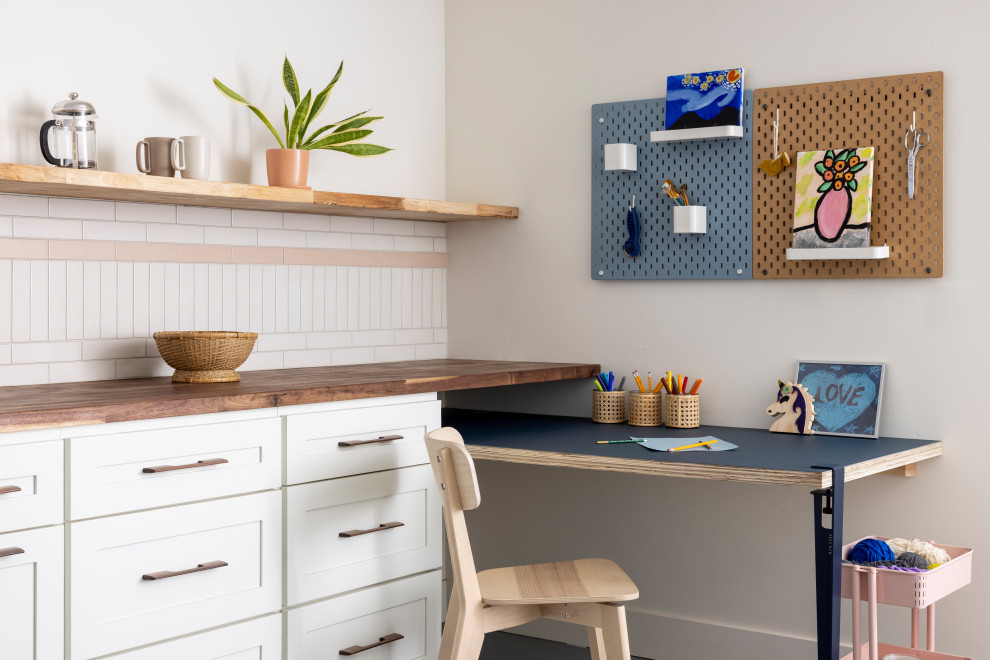 Inspiration for a small transitional gender-neutral linoleum floor and blue floor playroom remodel in Sacramento with white walls