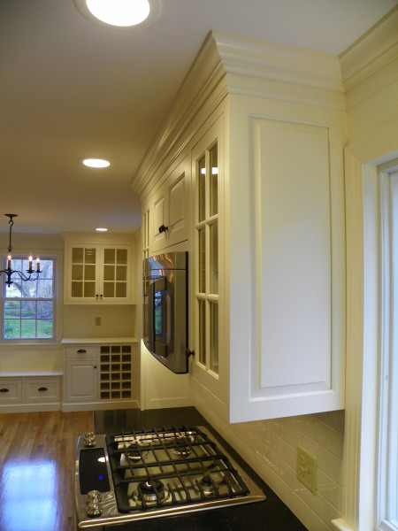 Inspiration for a mid-sized transitional u-shaped light wood floor eat-in kitchen remodel in Boston with an undermount sink, beaded inset cabinets, white cabinets, quartz countertops, white backsplash, subway tile backsplash, stainless steel appliances and no island