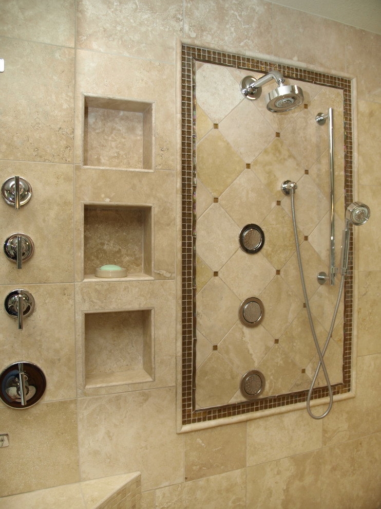 This is an example of a mid-sized contemporary master bathroom in Austin with a drop-in tub, a corner shower, beige tile, limestone, beige walls and limestone floors.