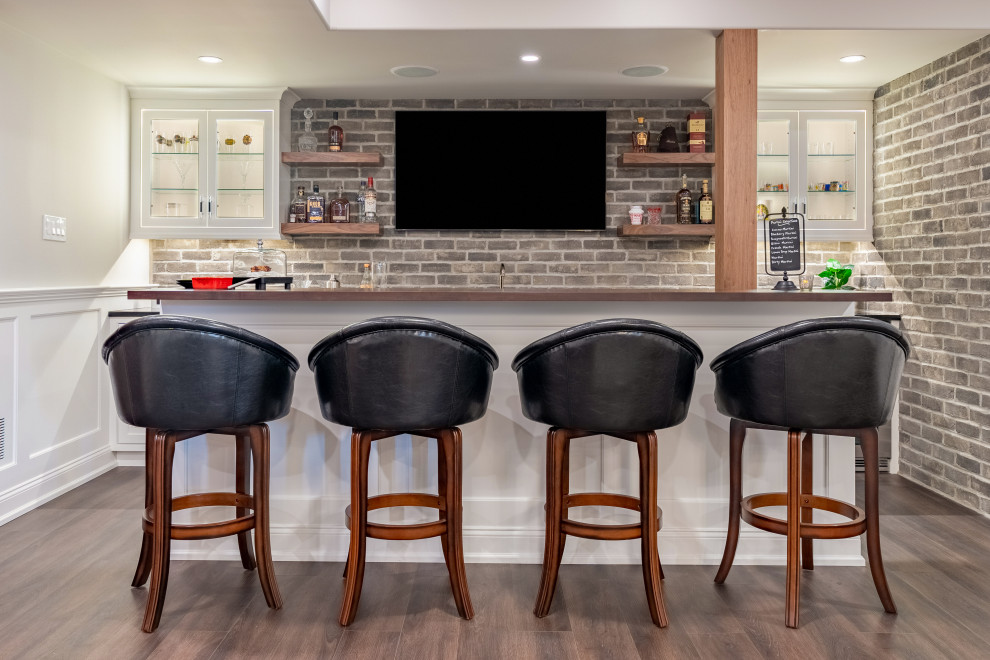 Design ideas for an expansive transitional open concept family room in Philadelphia with a home bar, multi-coloured walls, vinyl floors, a built-in media wall, grey floor and decorative wall panelling.