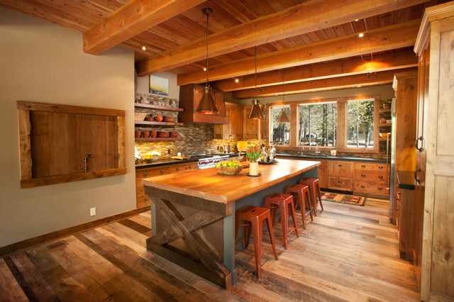 Eat-in kitchen - large rustic u-shaped medium tone wood floor eat-in kitchen idea with recessed-panel cabinets, light wood cabinets, wood countertops, multicolored backsplash, matchstick tile backsplash, an island, an undermount sink and stainless steel appliances