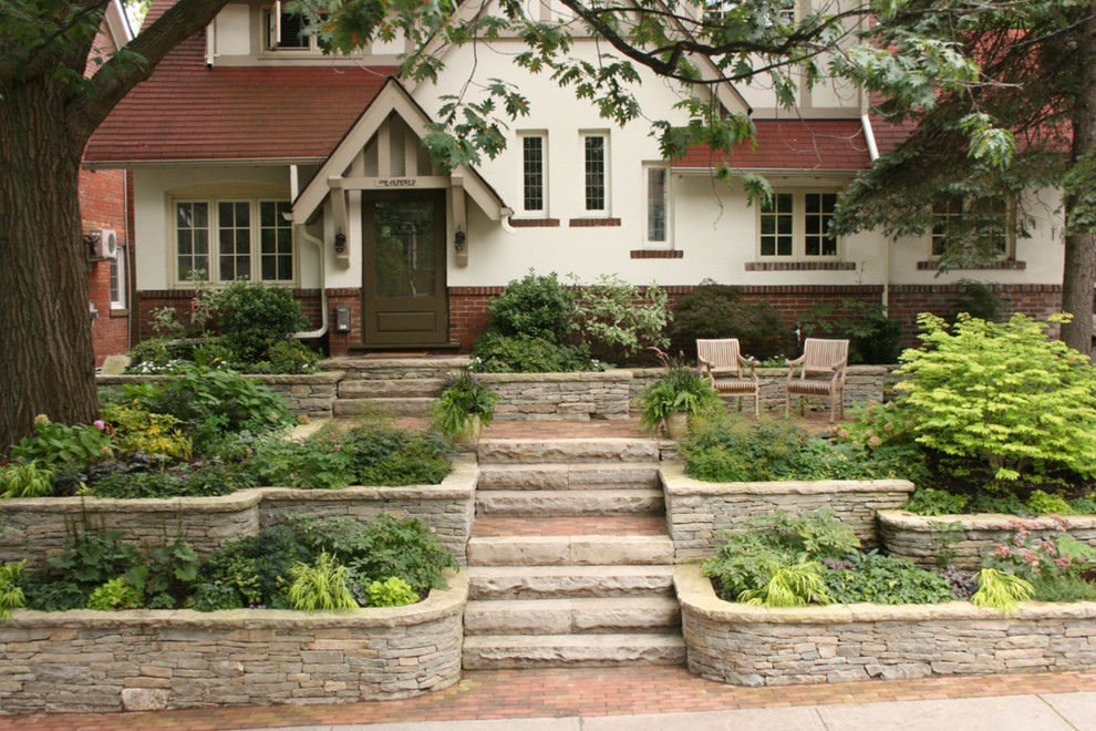 Design ideas for a mid-sized arts and crafts front yard garden in Toronto with a garden path and brick pavers.