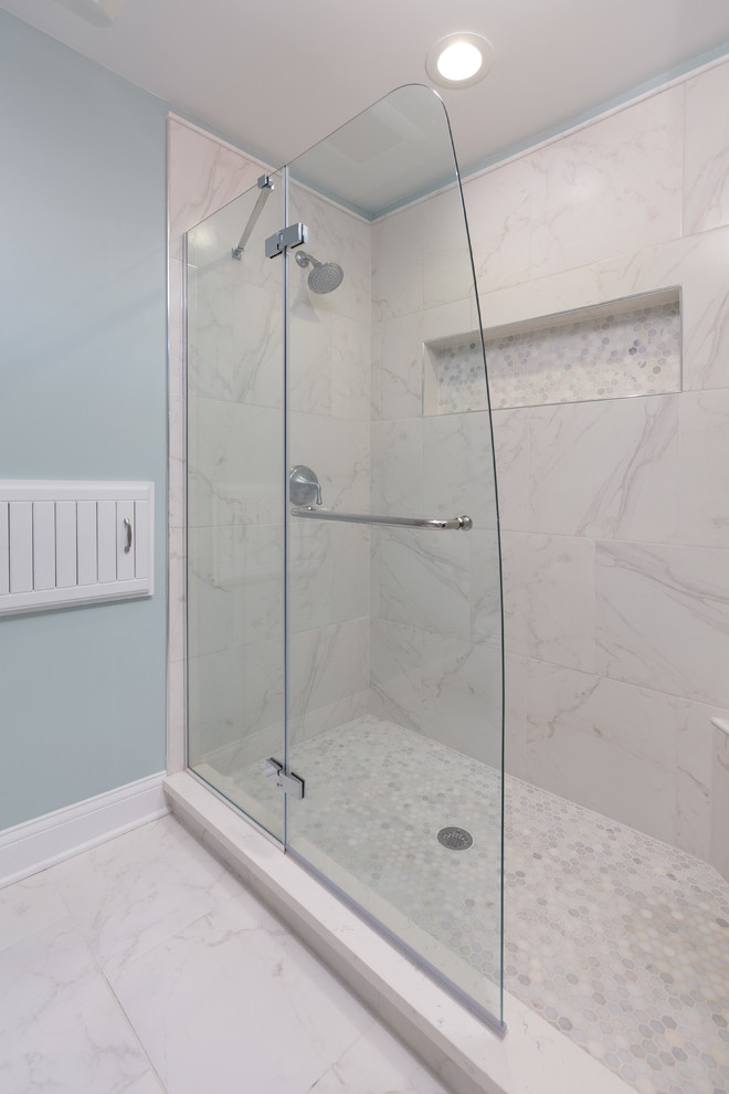 Inspiration for a mid-sized modern master bathroom in Chicago with raised-panel cabinets, white cabinets, a freestanding tub, a corner shower, a one-piece toilet, white tile, stone slab, blue walls, marble floors, an undermount sink and marble benchtops.