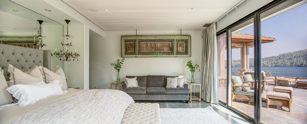 Large contemporary master bedroom in Seattle with white walls, concrete floors and no fireplace.
