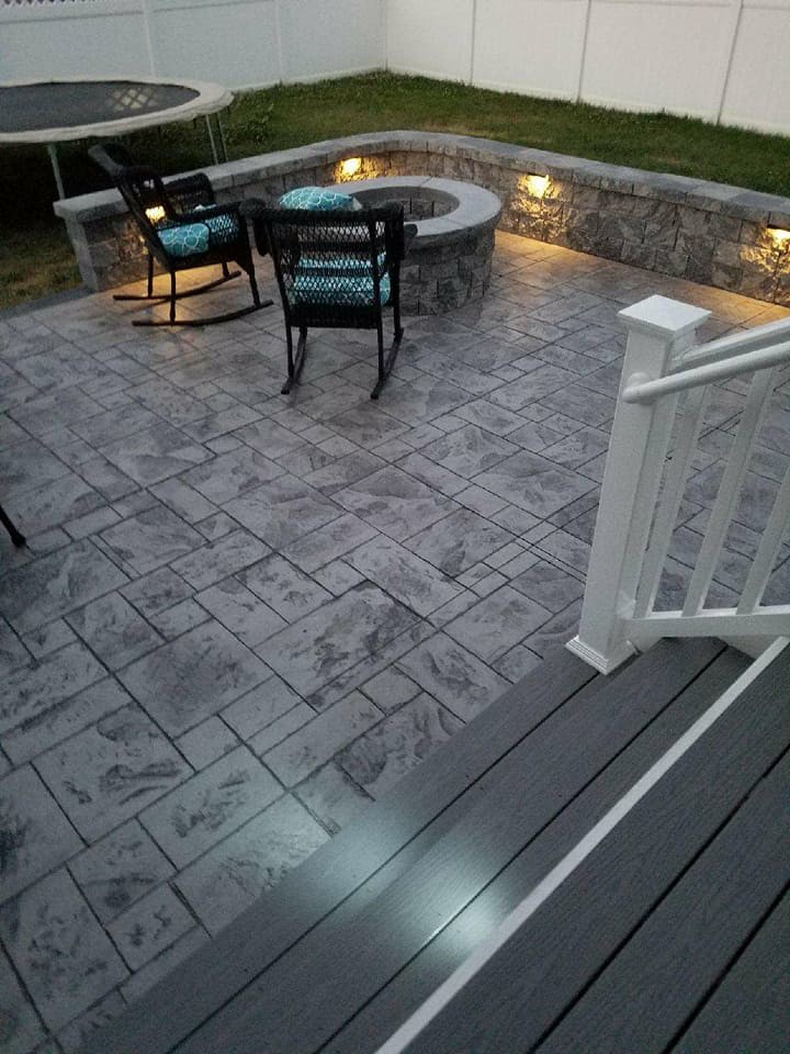 Design ideas for a mid-sized backyard patio in Other with a fire feature, stamped concrete and no cover.