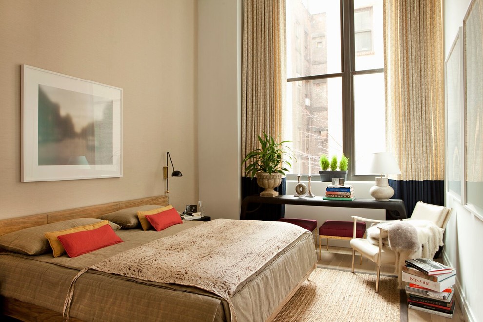 Photo of a contemporary master bedroom in New York with beige walls.
