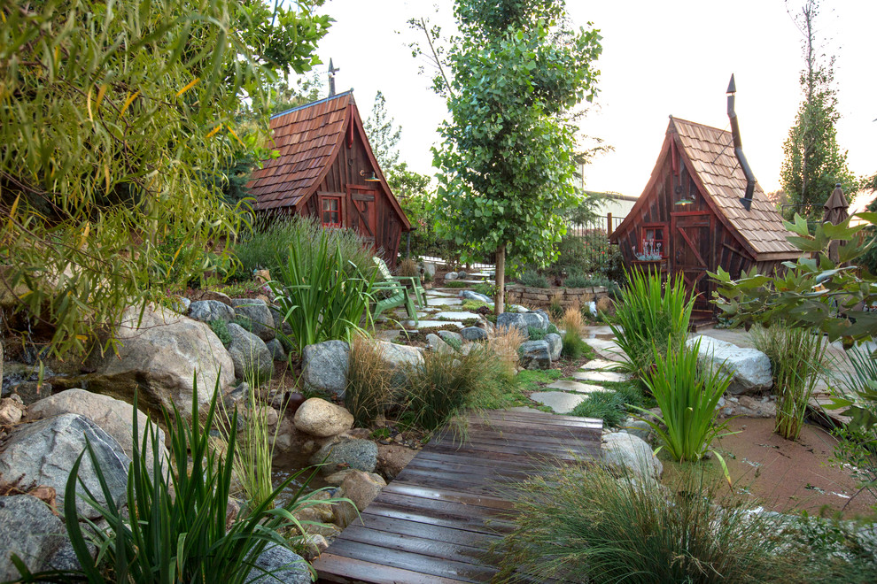 Design ideas for a country backyard garden in Sacramento with a water feature.