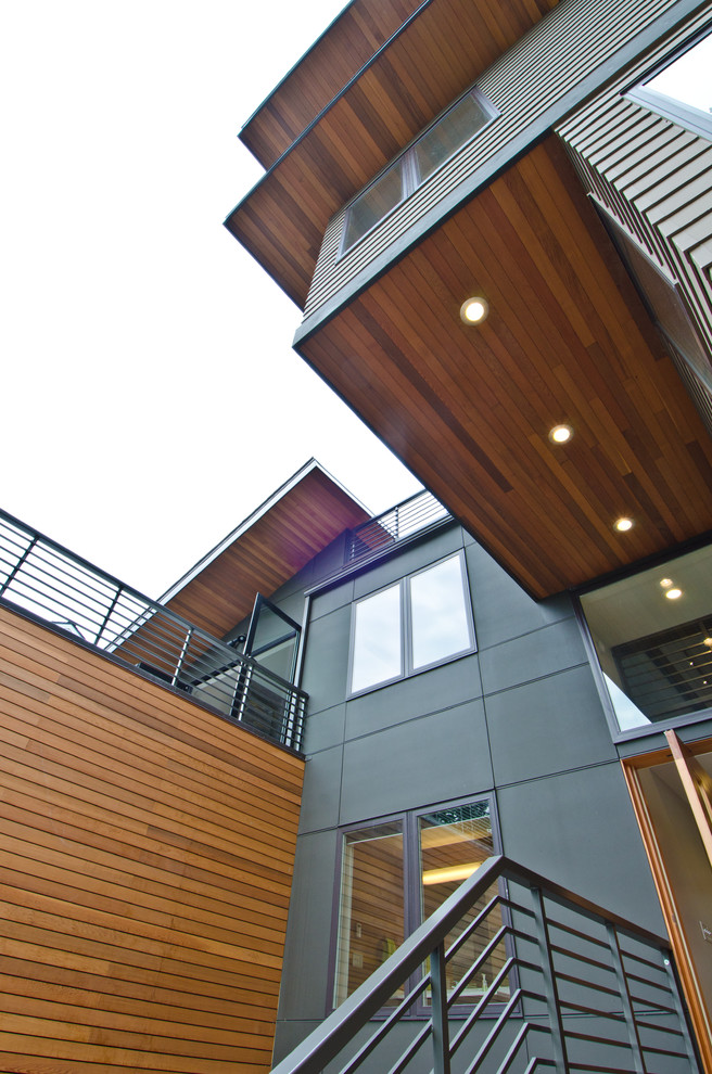 Design ideas for a large modern three-storey brown exterior in Seattle with wood siding.