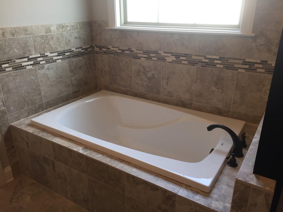 Mid-sized traditional master bathroom in Nashville with a drop-in tub, beige tile, brown tile, white tile, matchstick tile, beige walls and ceramic floors.
