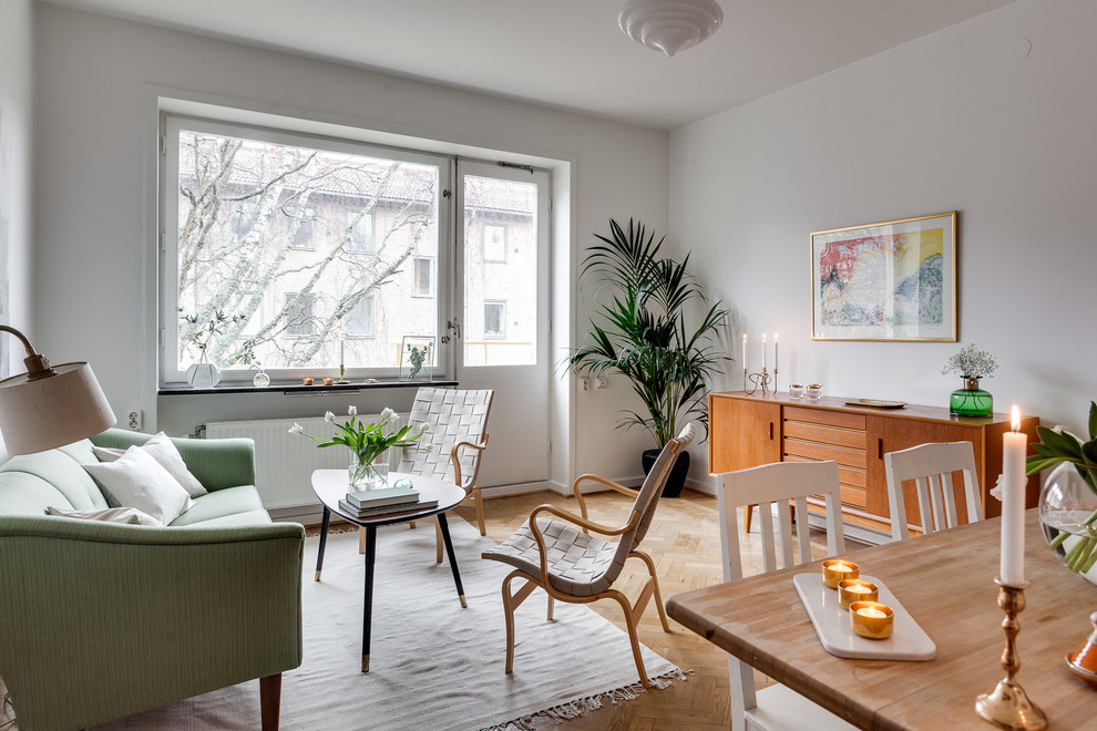 Inspiration for a mid-sized scandinavian formal enclosed living room in Stockholm with white walls, light hardwood floors, no fireplace and no tv.