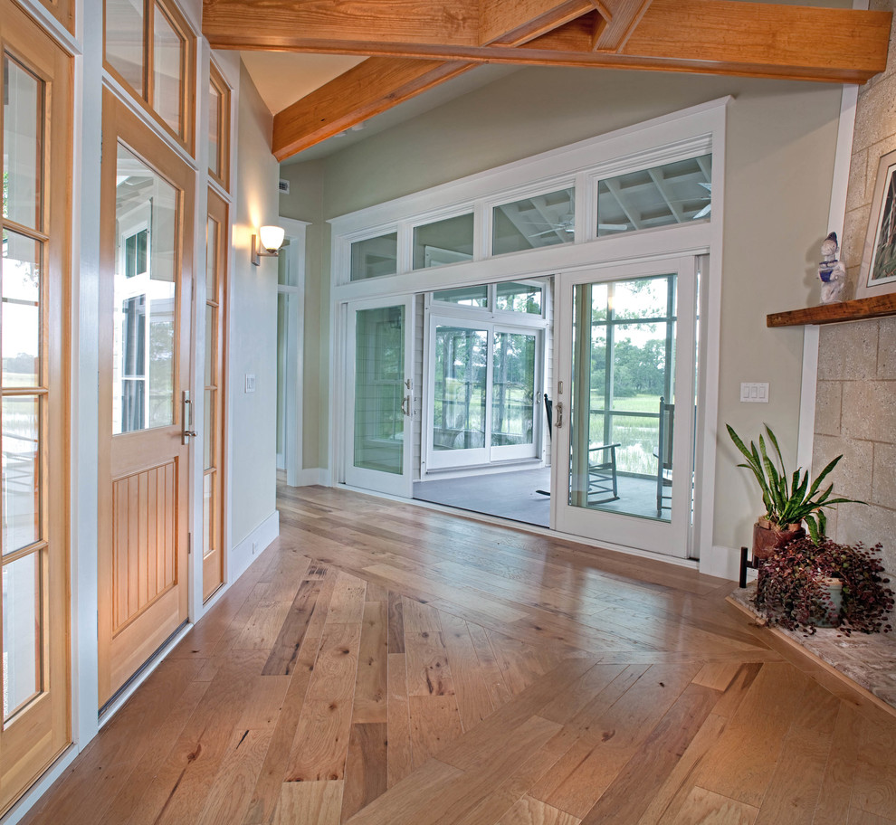 Inspiration for a mid-sized transitional medium tone wood floor foyer remodel in Atlanta with green walls and a medium wood front door