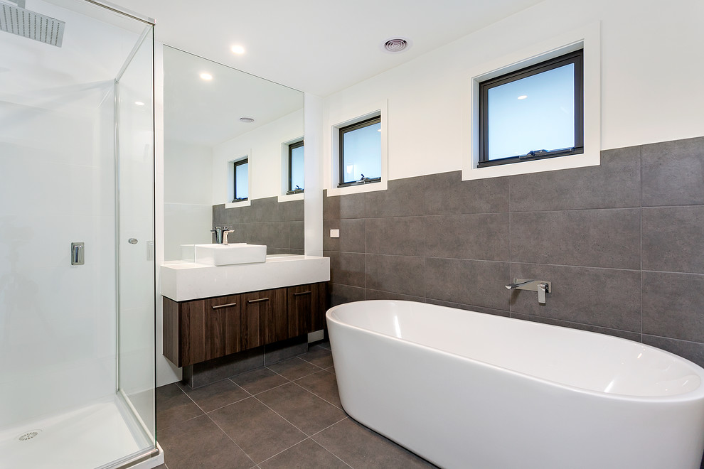 Design ideas for a mid-sized contemporary kids bathroom in Melbourne with a freestanding tub, a corner shower, gray tile, ceramic tile, white walls, ceramic floors, a vessel sink, grey floor and a hinged shower door.