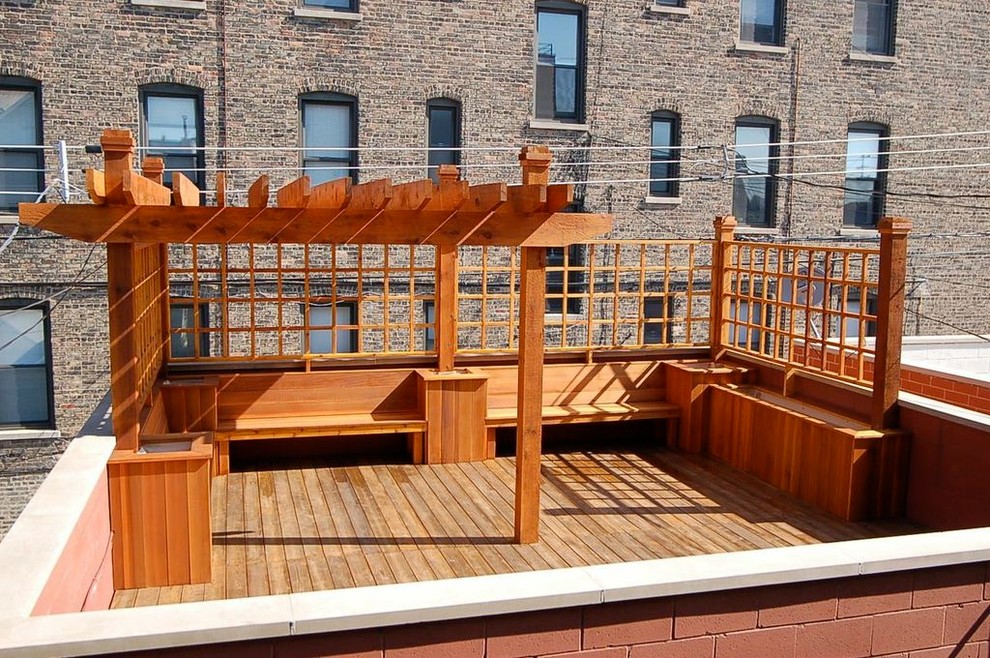 Inspiration for a large transitional rooftop deck remodel in Chicago with decking and a pergola
